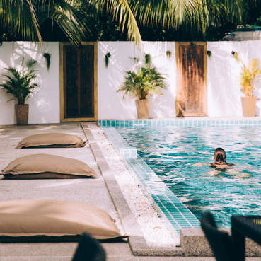 person swimming in clear pool cropped
